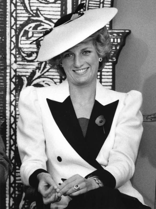 Princess Diana responds to reporters' questions after she and her husband Prince Charles toured the National Gallery of Art on November 10, 1985. Diana died in a car crash August 31, 1997. File Photo by Doug Mills/UPI