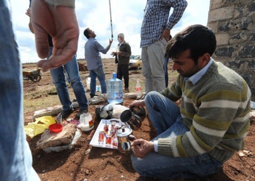 People take a break after working at a building site at Viransehir in Urfa. Kurdish people are building their own village near Viransehir city, using the stones they cut from volcanic rocks that can be found all around. Democratic Society Congress (DTK), an umbrella organization for local Kurdish groups in southeast Turkey, and an activist, Metin Yegin, jointly organize the project