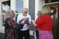 Labour Party leader Jeremy Corbyn meets local residents in Worthing, West Sussex, England, Wednesday, May 23, 2019 as voters head to the polls for the European Parliament election. Voters in Britain and the Netherlands are the first to cast their ballots in the four-day election for members of the European Parliament. (Andrew Matthews/PA via AP)