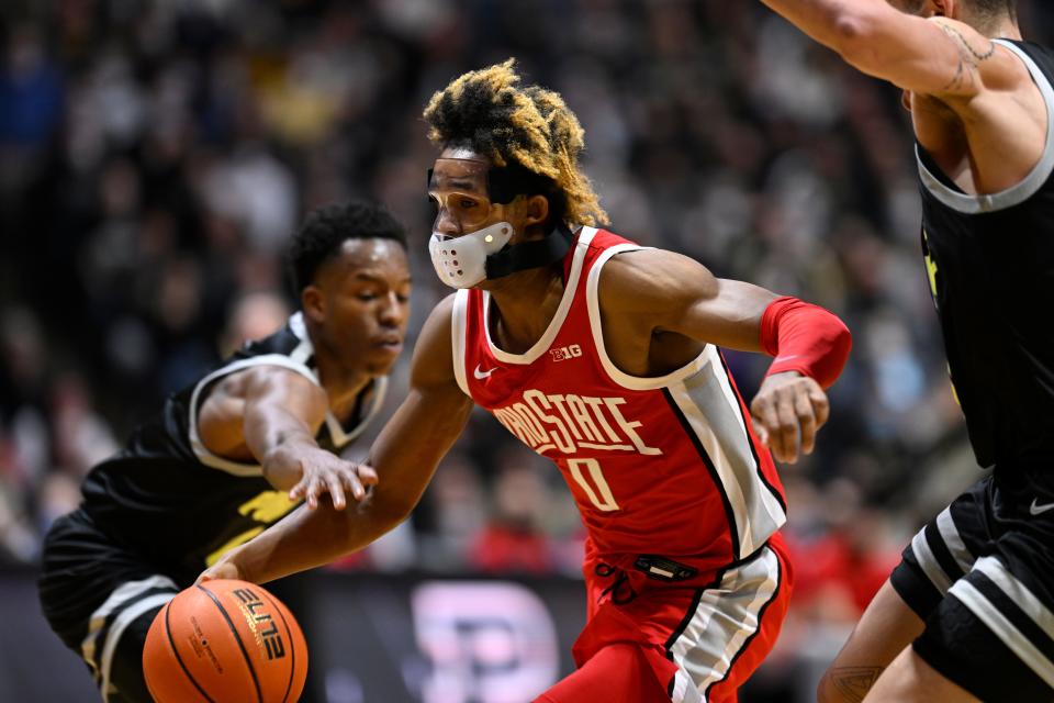 Jan 30, 2022; West Lafayette, Indiana, USA; Ohio State Buckeyes guard Meechie Johnson Jr. (0) drives between Purdue Boilermakers forward Mason Gillis (0) and Purdue Boilermakers guard Eric Hunter Jr. (2) during the first half at Mackey Arena. Mandatory Credit: Marc Lebryk-USA TODAY Sports