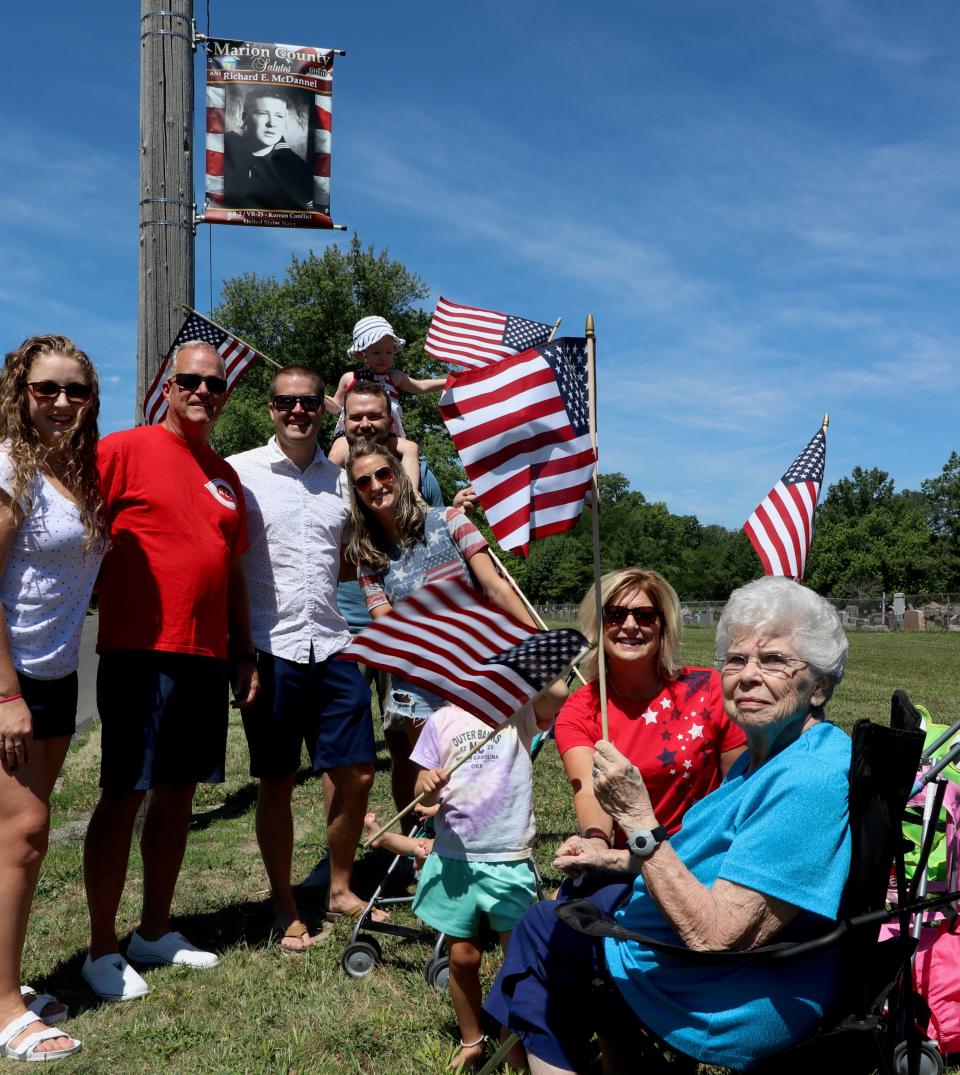 The family of Korean War veteran Richard E. "Dick" McDaniel of Marion County stands under his banner during the Stand by Your Veterans event held Saturday, July 2, 2022, in Marion. The next event is scheduled for Saturday, July 1, 2023, in Marion.