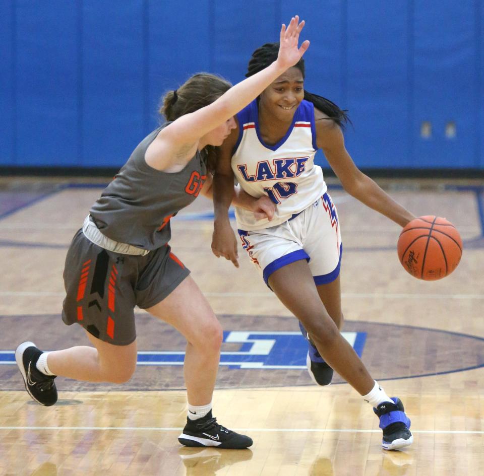 Serenitee Johnson (right) of Lake brings the ball up court while being pressured by Madi Pukansky (left) of Green during their game at Lake on Monday, Jan. 18, 2021.