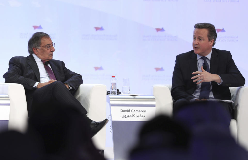 In this photo released by Emirates News Agency, WAM, former CIA director Leon Panetta, left, talks with David Cameron, former Prime Minister of the United Kingdom during the opening day of Arab Strategy Forum in Dubai, United Arab Emirates, Wednesday Dec. 14, 2016. Panetta and Cameron offered simple advice on Wednesday for U.S. President-elect Donald Trump: Have daily intelligence briefings. (Emirates News Agency via AP)