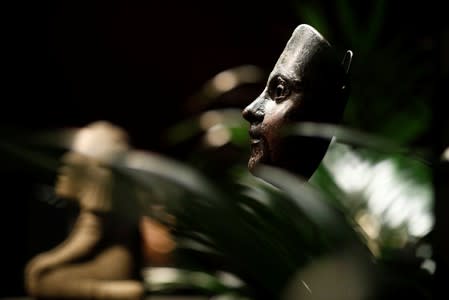 A dancing mask with the face of an angel, one of pre-Columbian artefacts, is presented to the press at Drouot auction house in Paris