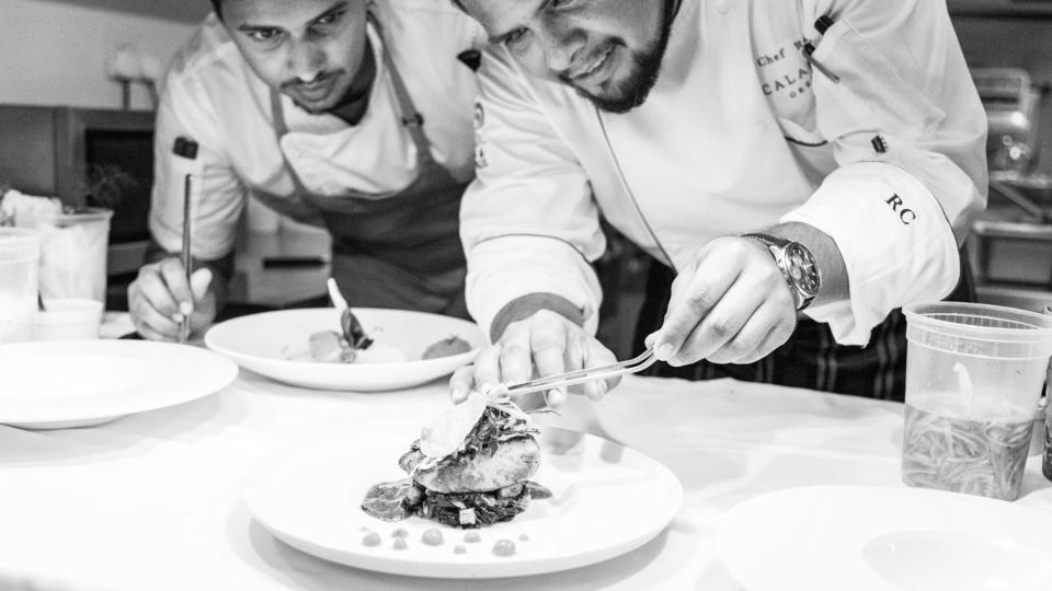 Chefs prepare a meal at the Calabash hotel