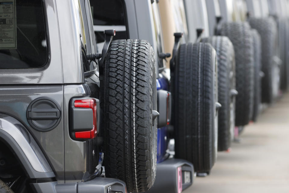 FILE - Spare tires are seen on a long row of unsold 2020 Wranglers sit at a Jeep dealership in Englewood, Colo., on April 26, 2020. The 13 largest U.S. tire manufacturers are facing a lawsuit from a pair of California commercial fishing organizations that could force the companies to either remove a chemical found in almost every tire that kills migrating salmon or obtain a permit to lawfully harvest species. (AP Photo/David Zalubowski, File)