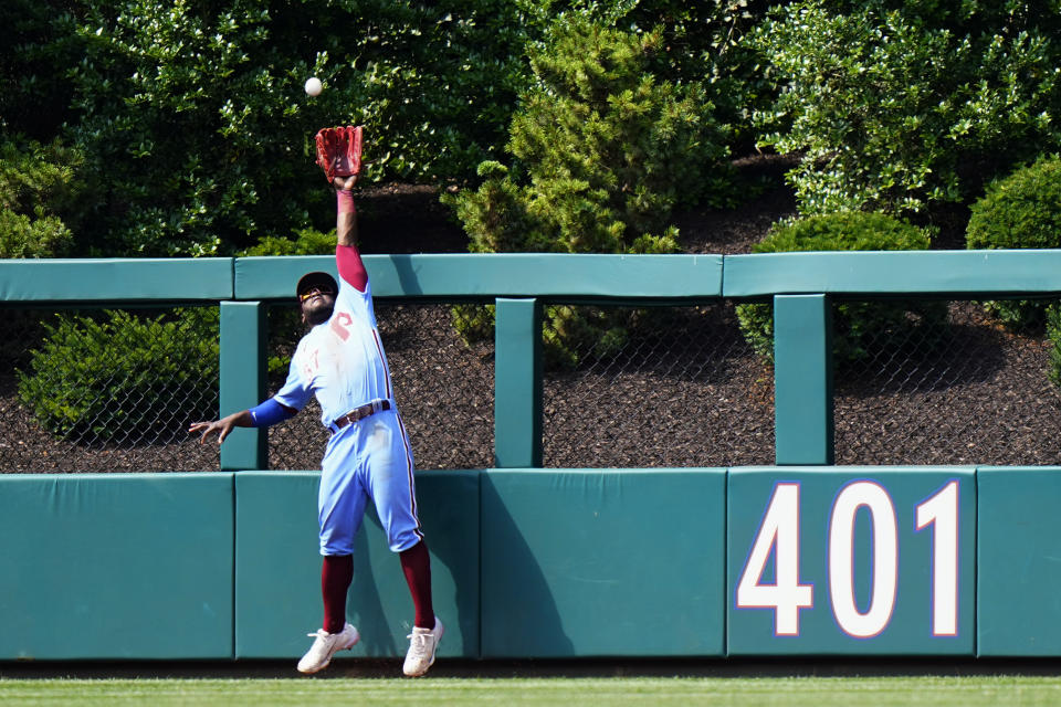 Philadelphia Phillies center fielder Odubel Herrera cannot reach a home run by Atlanta Braves' Freddie Freeman during the ninth inning of a baseball game, Thursday, June 10, 2021, in Philadelphia. (AP Photo/Matt Slocum)