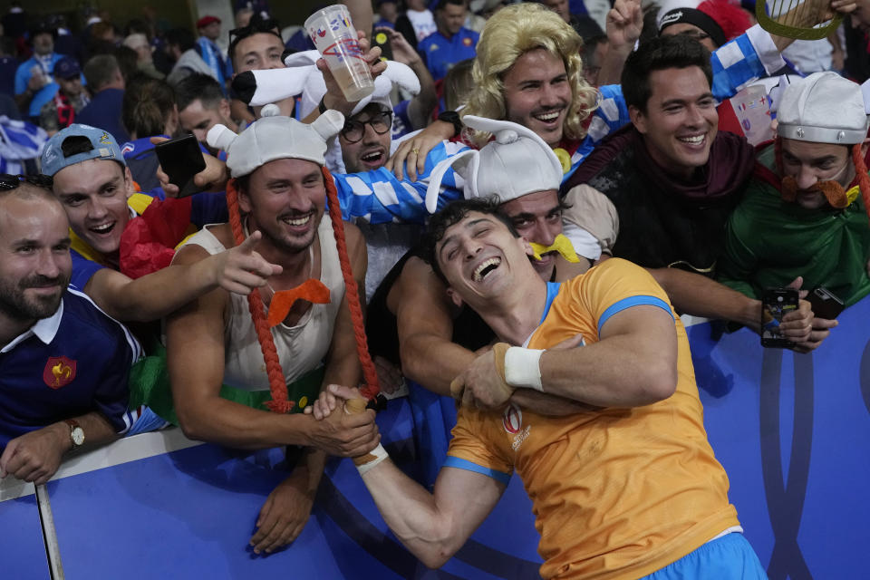 Uruguay's Baltazar Amaya poses for a picture with fans after the Rugby World Cup Pool A match between France and Uruguay at the Pierre Mauroy stadium in Villeneuve-d'Ascq, near Lille, France, Thursday, Sept. 14, 2023. (AP Photo/Thibault Camus)