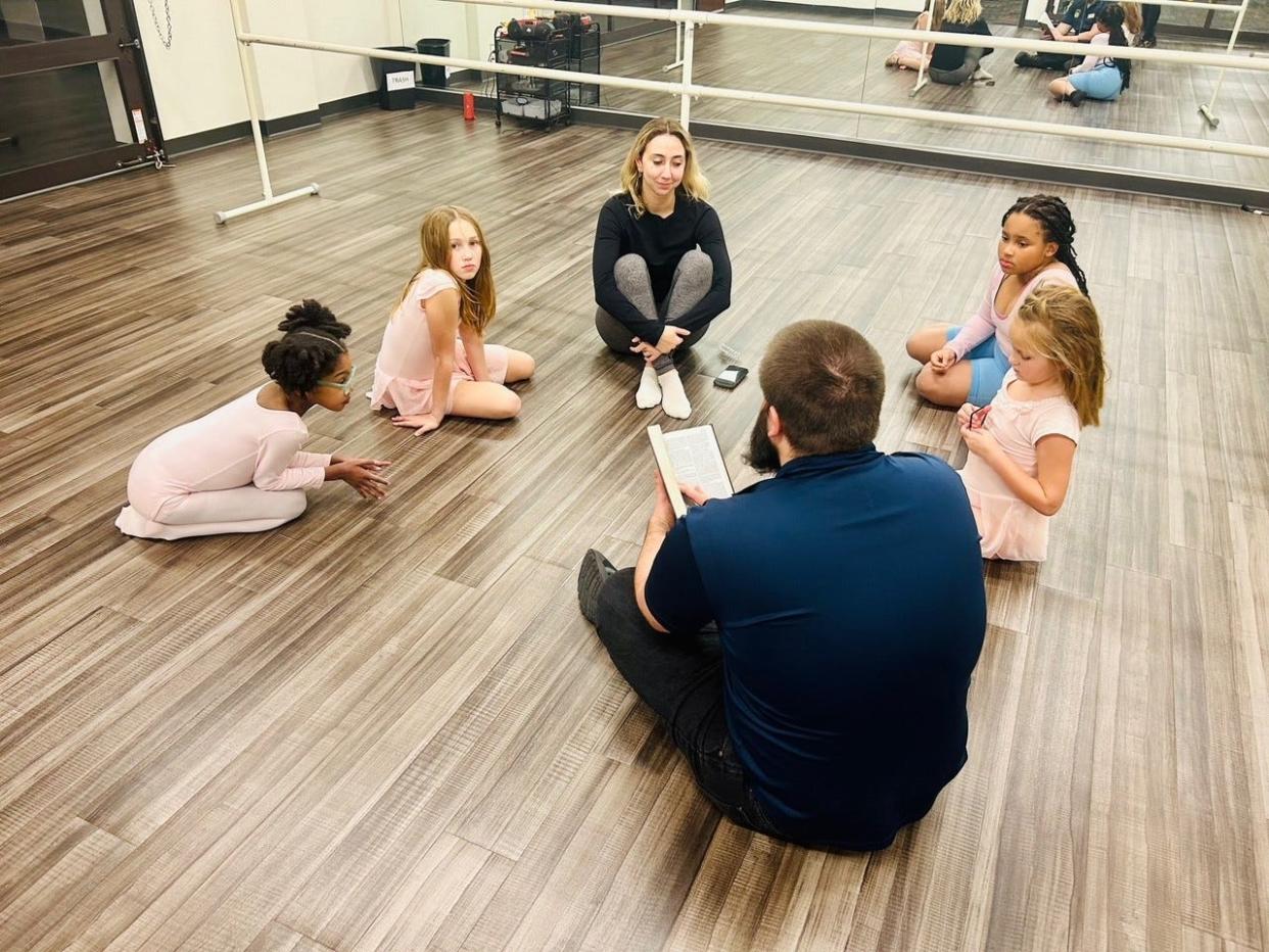 A Chaplin reads passages from the Bible to girls taking ballet at Above the Clouds on Dec. 7. The nonprofit provides free classes to youth ages 5 to 17 for the last 21 years. Above the Clouds is facing a $50,000 shortfall this year after checks were stolen and washed and thieves discarded grant applications.