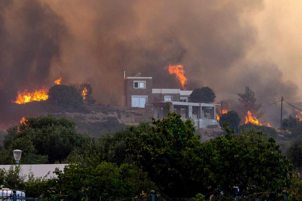 <p>Christoph Reichwein/picture alliance via Getty Images</p>  At noon, a new forest fire broke out near the village of Gennadi, in the evening the flames reach a first settlement, several houses are destroyed on July 25, 2023. 