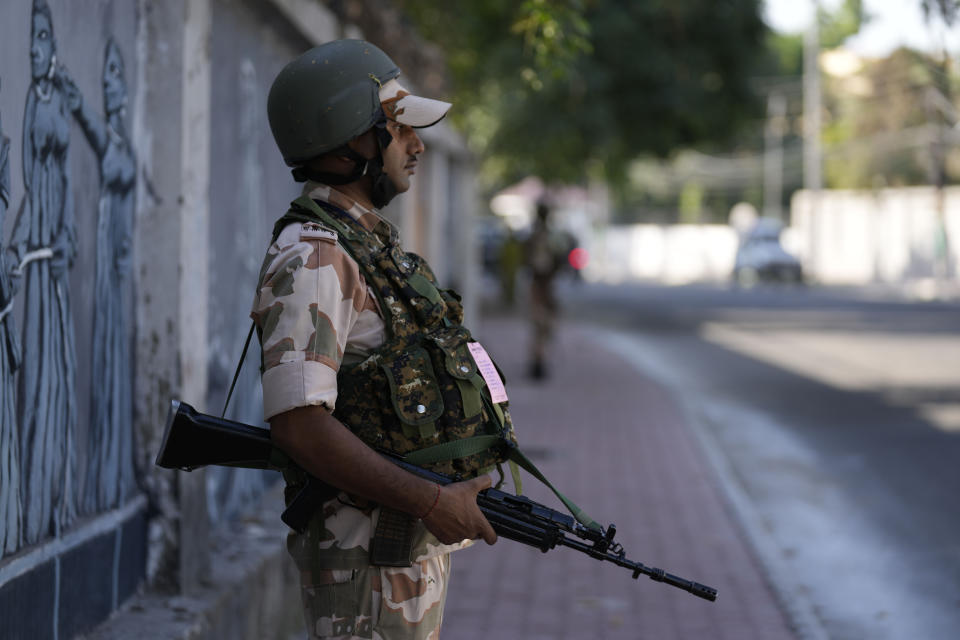 Paramilitary soldiers patrol a street in Jammu, India, Tuesday, Oct. 4, 2022. The prisons chief in Indian-controlled Kashmir has been killed, officials said Tuesday, as India’s powerful home minister arrived in the disputed Himalayan region on a three-day visit. (AP Photo/Channi Anand)