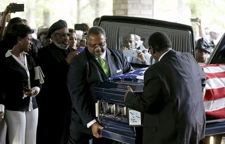 The casket of Walter Scott is removed from a hearse for his funeral at W.O.R.D. Ministries Christian Center, Saturday, April 11, 2015, in Summerville. REUTERS/David Goldman/Pool