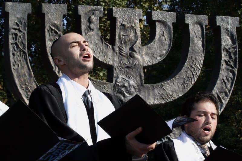 A Jewish choir performs at the menorah monument at the Babi Yar ravine in Kiev on September 27, 2006. File Photo by Sergey Starostenko/UPI