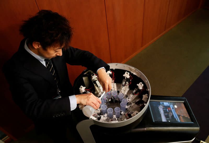 Demonstration of Taste the TV (TTTV), a prototype lickable TV screen that can imitate the flavours of various foods in Tokyo