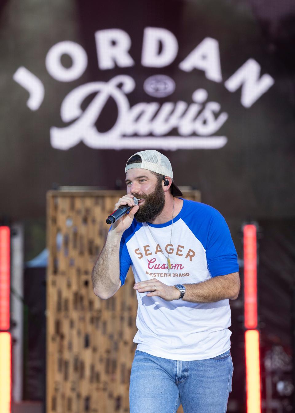 Jordan Davis, shown singing at the Gulf Coast Jam at Panama City Beach, will perform at 7 p.m. Saturday at Tom Benson Hall of Fame Stadium as part of the Fatherhood Festival at the Hall of Fame Village. For ticket information, visit the village's website. Children 12 and under are admitted free.