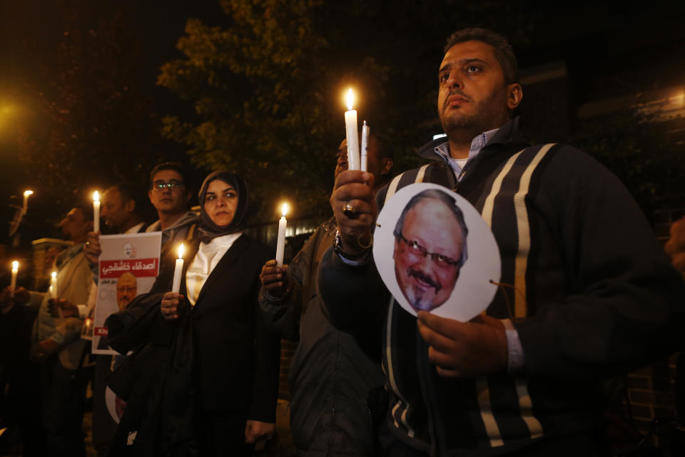 Activists, protesting the killing of Saudi journalist Jamal Khashoggi, hold a candlelight vigil outside Saudi Arabia's consulate in Istanbul, Thursday, Oct. 25, 2018. A group of Arab and international public, political and media figures are establishing a global association called "Khashoggi's Friends Around the World"; "to achieve justice for the freedom martyr".(AP Photo/Lefteris Pitarakis)