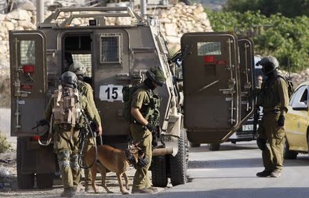 Israeli soldiers take part in an operation to locate three Israeli teens near the West Bank City of Hebron June 19, 2014. REUTERS/Mussa Qawasma