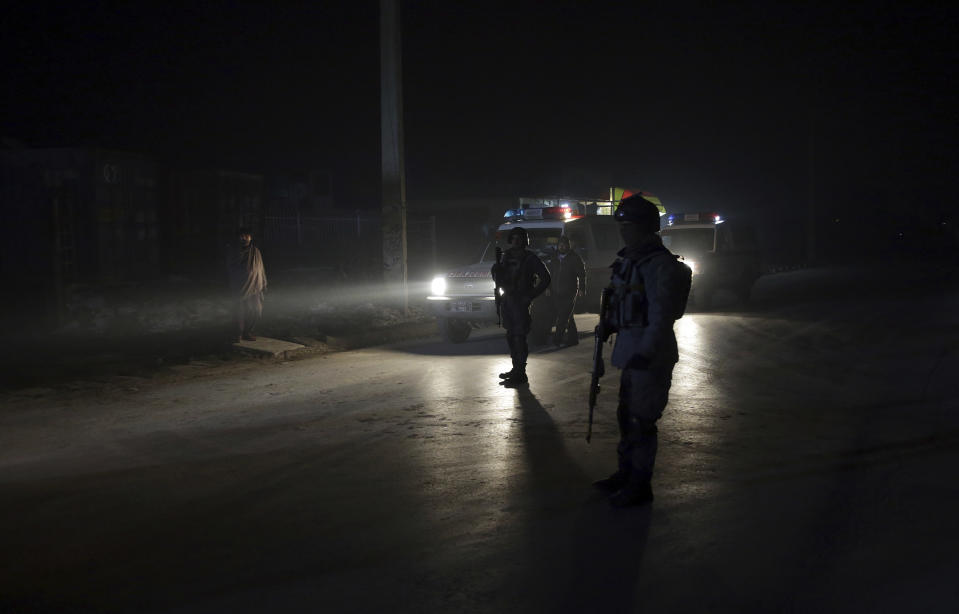Policemen block the road near the site of a suicide attack in Kabul, Afghanistan, Monday, Jan. 14, 2019. Afghan officials say multiple people were killed when a suicide bomber detonated a vehicle full of explosive in the capital Kabul on Monday. (AP Photo/Massoud Hossaini)