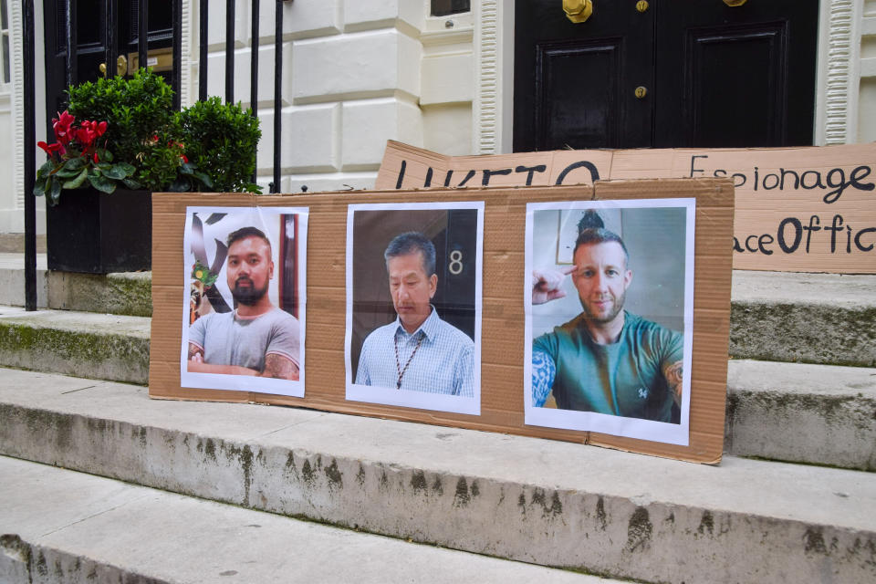 LONDON, UNITED KINGDOM - 2024/05/14: Pictures of Chi Leung Wai, Chung Biu Yuen, and Matthew Trickett, the men charged with alleged spying, are seen during the demonstration. UK Hong Kongers and supporters staged a protest outside the Hong Kong Economic and Trade Office (HKETO) in London against the Chinese Government's alleged spying and repression activities, following the arrest of three people on charges of spying for Hong Kong. (Photo by Vuk Valcic/SOPA Images/LightRocket via Getty Images)