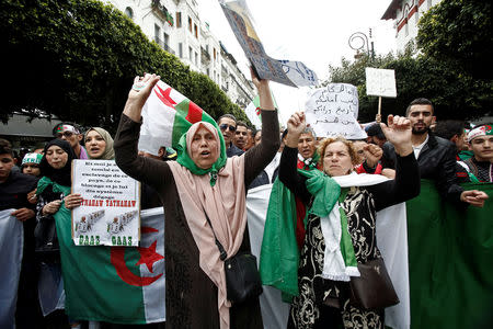 Demonstrators hold flags and banners as they return to the streets to press demands for wholesale democratic change well beyond former president Abdelaziz Bouteflika's resignation, in Algiers, Algeria April 19, 2019. REUTERS/Ramzi Boudina