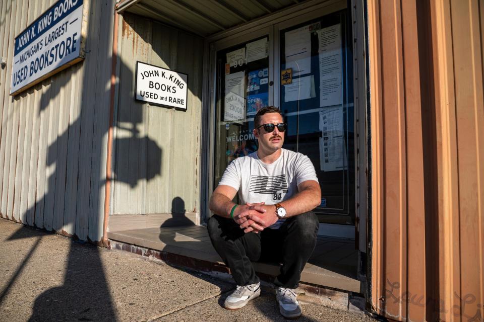Don "DJ" Rentz, a Detroit-area native, sits outside the John K. King Used & Rare Books store in Detroit on Thursday, Sept. 1, 2022.