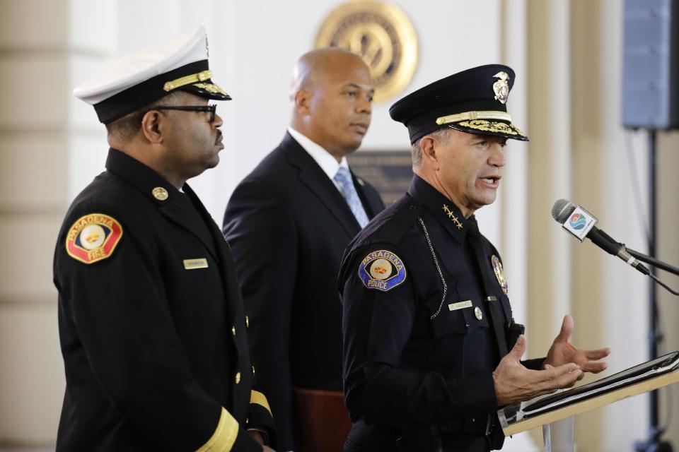 Pasadena Police Chief Phillip Sanchez, right, speaks about safety issues ahead of next week's 128th Rose Parade as he is joined by Pasadena Fire Chief Bertral Washington, left, and Rob Savage, special agent in charge of the U.S. Secret Service Wednesday, Dec. 28, 2016, in Pasadena, Calif. (AP Photo/Jae C. Hong)