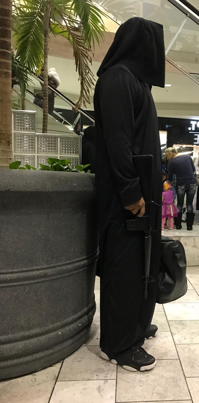 A man in a hooded costume, wielding what looked like a real firearm, spooked several people at an Omaha, Neb., mall this Halloween weekend. (Photo: Facebook)