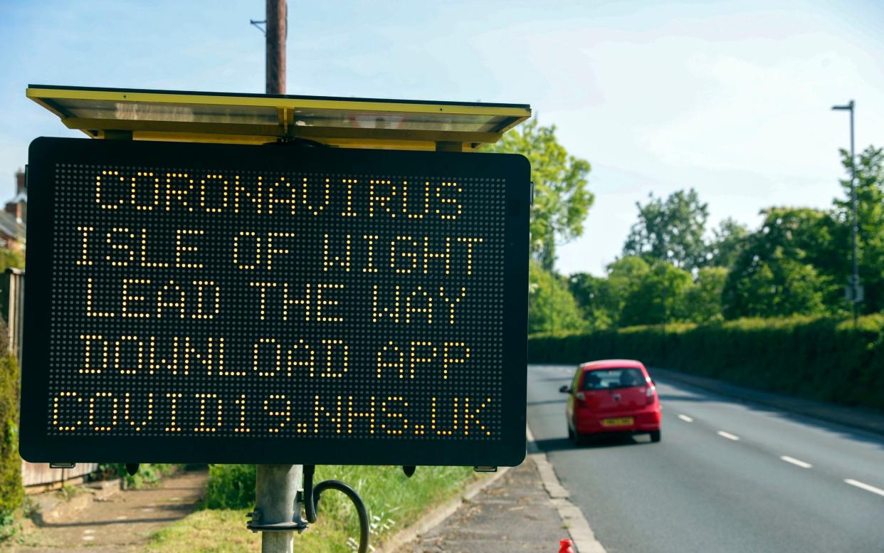 A sign telling people in the Isle of Wight to download the NHS coronavirus contact tracing app - Isle of Wight contact tracing trial undermined by people on UK mainland downloading the app - PA