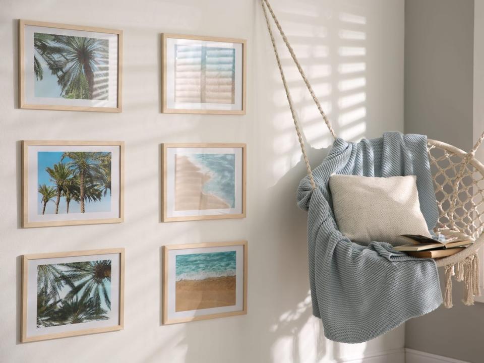 Six prints of photos next to a swinging chair.