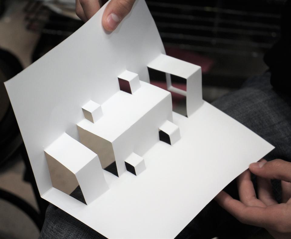 After speaking, popup book artist Matthew Reinhart led Wylie High School art students on a short journey on how to create three-dimensional art. With a few strategic snips of folded paper, each created their own presentation.