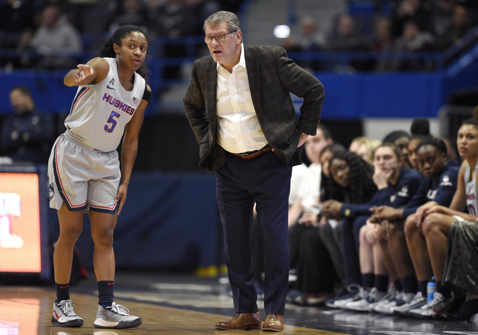 Connecticut's Crystal Dangerfield, left, talks with Connecticut Geno Auriemma during the first half of an NCAA college basketball game against Wichita State on Thursday, Jan. 2, 2020, in Uncasville, Conn. (AP Photo/Jessica Hill)