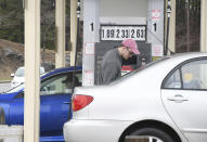 Brad Downey fills up his vehicle at the Stop&Shop gas station in Pittsfield, Mass. where regular unleaded gasoline was $1.89 gallon on Monday, March 30, 2020. (Gillian Jones/The Berkshire Eagle via AP)