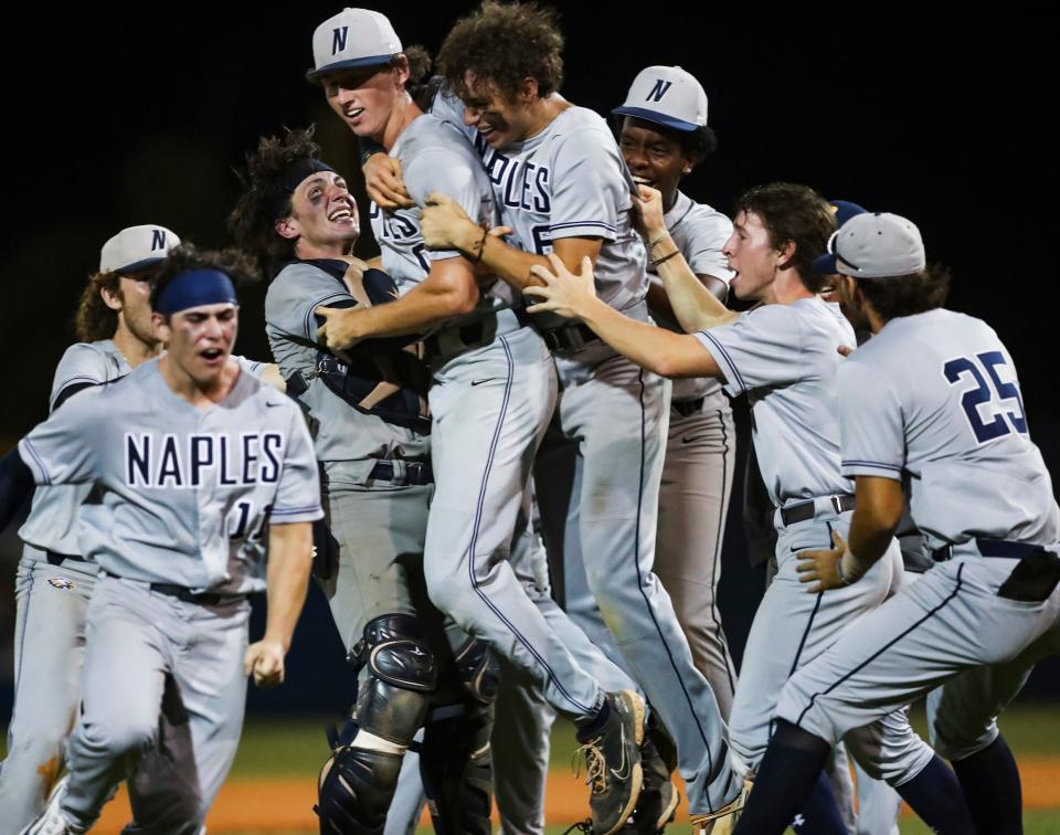 Naples Golden Eagles players celebrate with relief pitcher Nolan Bittner, center left, after the team won the Class 5A District 12 championship against the Barron Collier Cougars at Barron Collier High School in Naples on Thursday, May 2, 2024.