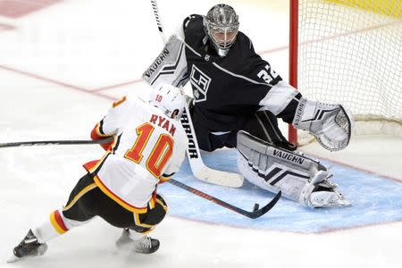 Apr 1, 2019; Los Angeles, CA, USA; Calgary Flames center Derek Ryan (10) shoots the puck under Los Angeles Kings goaltender Jonathan Quick (32) to score during the third period at Staples Center. Mandatory Credit: Jake Roth-USA TODAY Sports