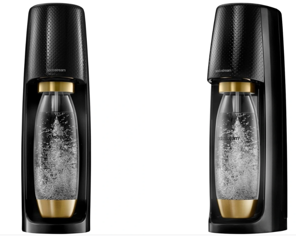 A front and side on image of the black SodaStream with gold caps on the bottom and top of the water bottle against a white background.