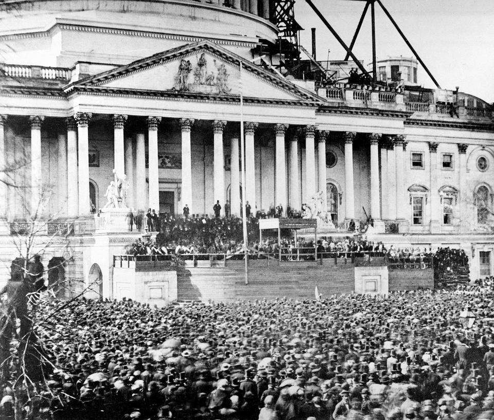 FILE - In this March 4, 1961 file image, President Abraham Lincoln stands under cover at center of Capitol steps during his inauguration in Washington. The scaffolding at upper right is used in construction of the Capitol dome. Historians cite the first inaugural speeches of Thomas Jefferson and Abraham Lincoln as possible parallels for Joe Biden, who has said his goal is to “restore the soul” of the country even as millions baselessly insist incumbent Donald Trump was the winner. (AP Photo)