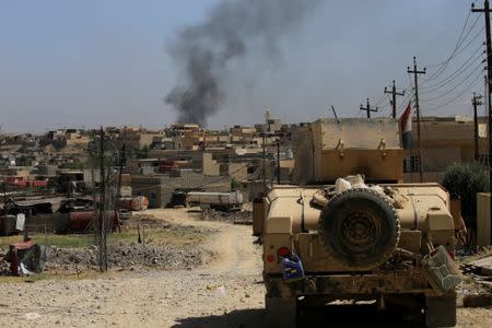 A military vehicle of Iraqi security forces drives during a battle between Iraqi forces and Islamic State militants in western Mosul, Iraq May 18, 2017. REUTERS/Alaa Al-Marjani