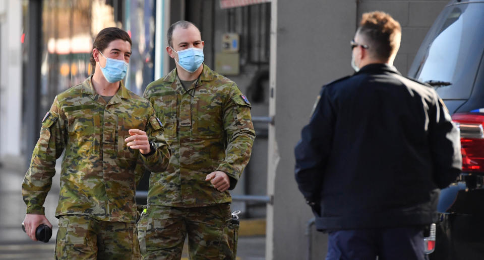 Australian Defence Force personnel and NSW police are seen at Fairfield in the south west suburb of Sydney, Monday, August 2, 2021. 300 ADF troops will reinforce the efforts of police, patrolling and door-knocking to ensure people are complying with coronavirus restrictions. Source: AAP