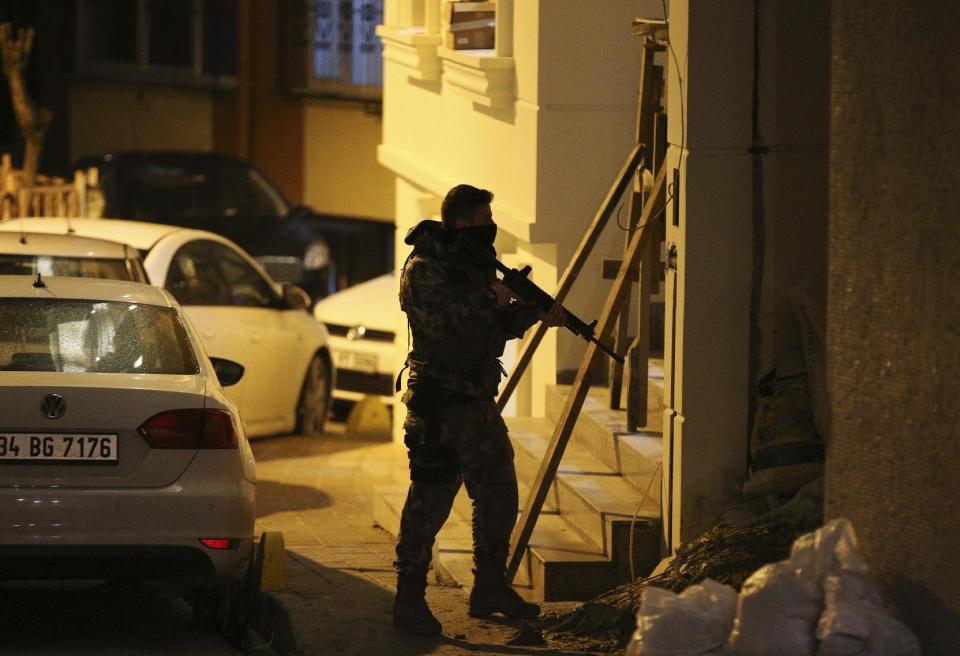 A Turkish police officer secures a road near Istanbul's main police headquarters, Friday, Jan. 20, 2017. A Turkish media report says a rocket-propelled grenade was fired near the headquarters but that it missed the building. There was no further information on the incident, which comes at a time when Turkey has suffered a series of deadly attacks carried out either by the Islamic State group or Kurdish militants.(AP Photo/Emrah Gurel)