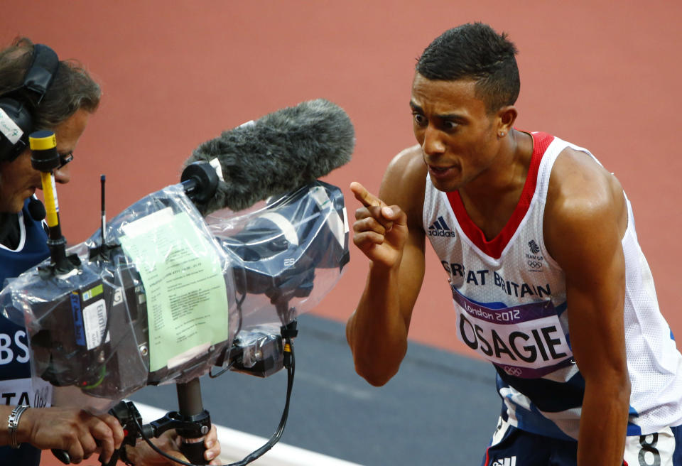 Britain's Andrew Osagie reacts in front of a television camera after his second place finish in his men's 800m semi-final during the London 2012 Olympic Games at the Olympic Stadium August 7, 2012. REUTERS/David Gray (BRITAIN - Tags: OLYMPICS SPORT ATHLETICS MEDIA) 