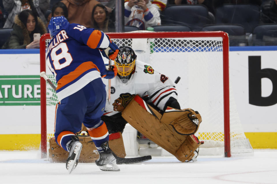 Chicago Blackhawks goaltender Marc-Andre Fleury, right, blocks New York Islanders left wing Anthony Beauvillier (18) during a shootout of an NHL hockey game, Sunday, Dec. 5, 2021, in Elmont, N.Y. (AP Photo/Corey Sipkin).