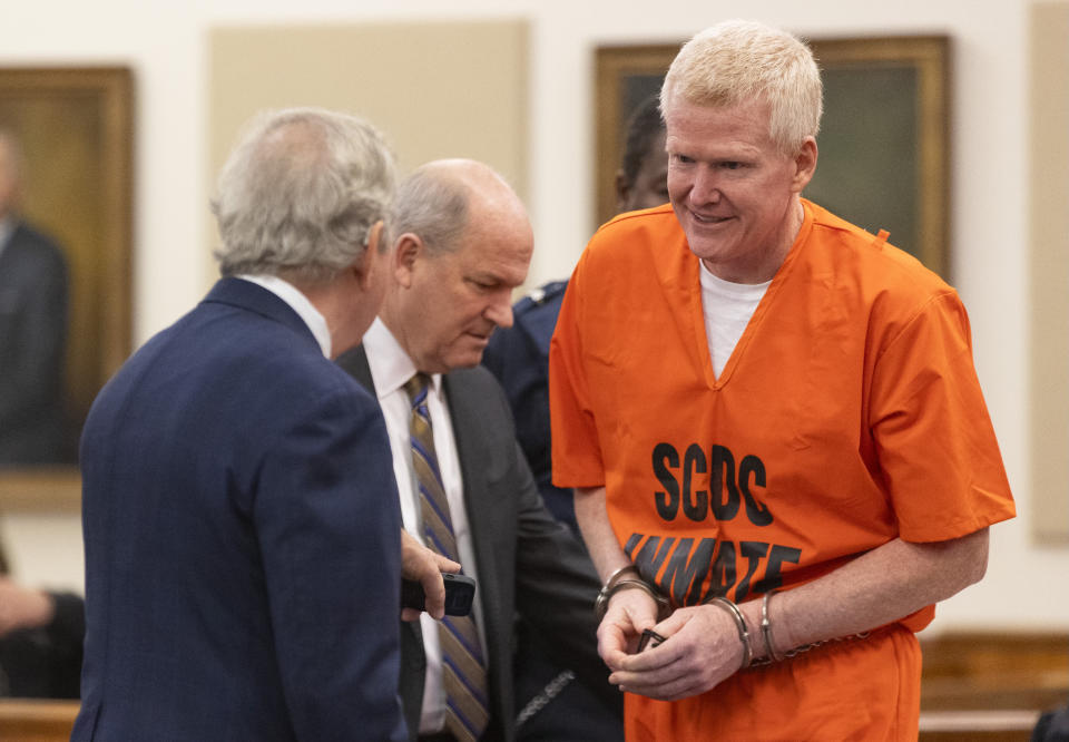 Alex Murdaugh talks with his attorneys Dick Harpootlian, left, and Jim Griffin during his sentencing for stealing from 18 clients, Tuesday, Nov. 28, 2023, at the Beaufort County Courthouse in Beaufort, S.C. (Andrew J. Whitaker/The Post And Courier via AP, Pool)