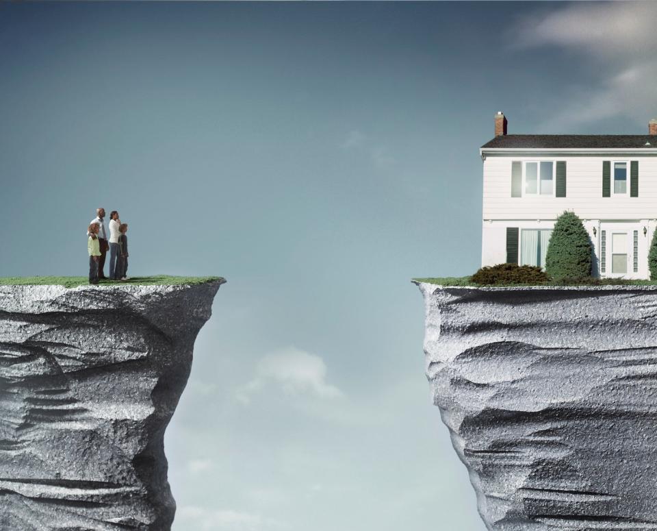 People on a cliff looking at a house on another cliff they can't reach
