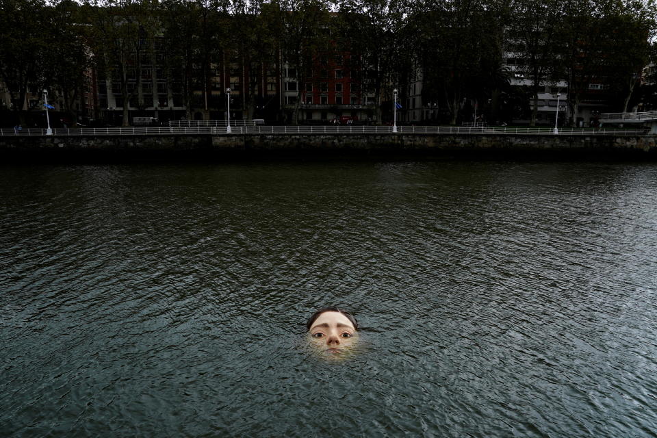 A fibreglass sculpture entitled 'Bihar' (Tomorrow in Basque), by Mexican hyperrealist artist Ruben Orozco, is submerged in the Nervion river in Bilbao, Spain, September 27, 2021. REUTERS/Vincent West     TPX IMAGES OF THE DAY