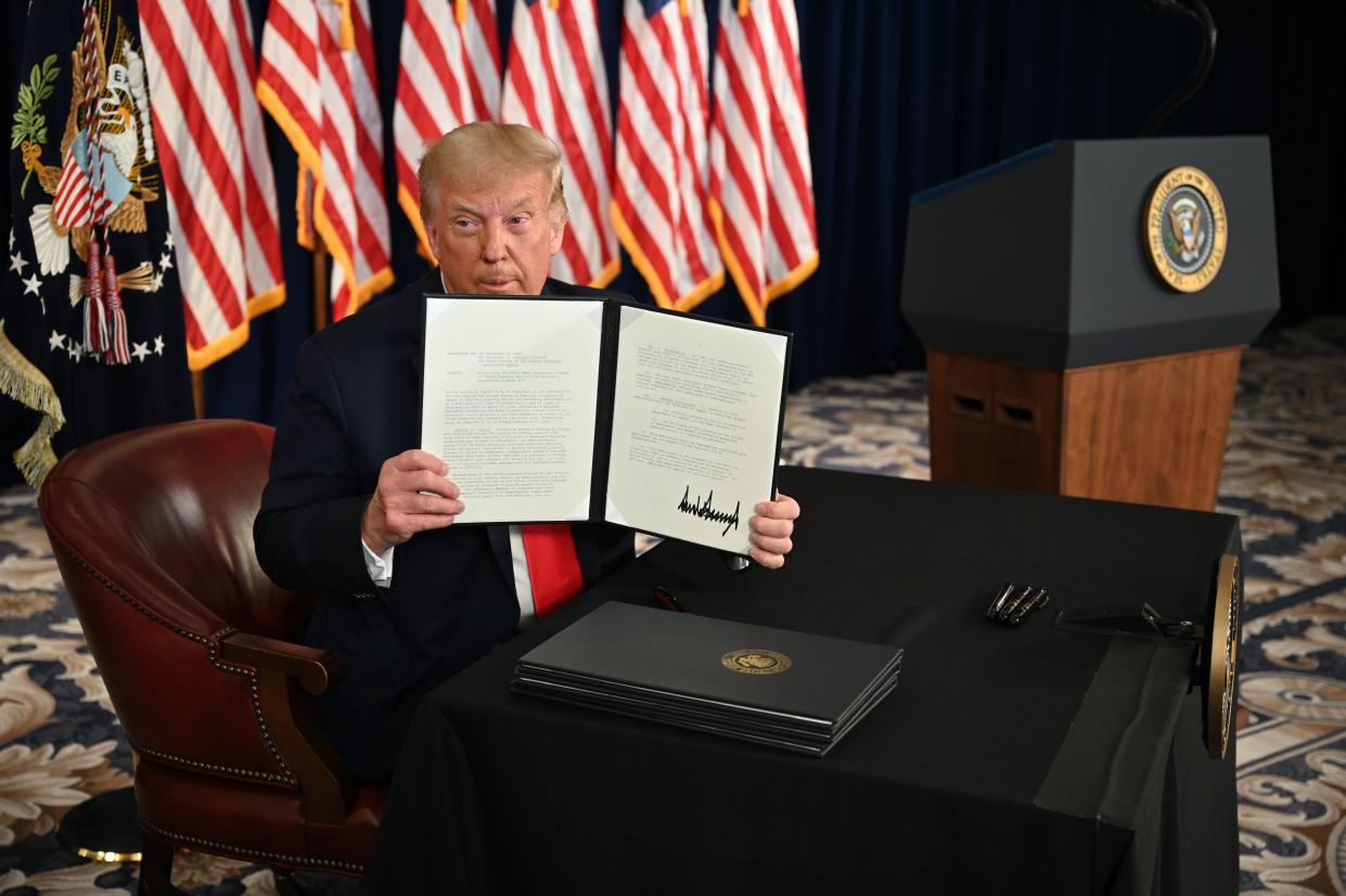 US President Donald Trump signs executive orders extending coronavirus economic relief, during a news conference in Bedminster, New Jersey, on August 8, 2020. (Photo by JIM WATSON / AFP) (Photo by JIM WATSON/AFP via Getty Images)