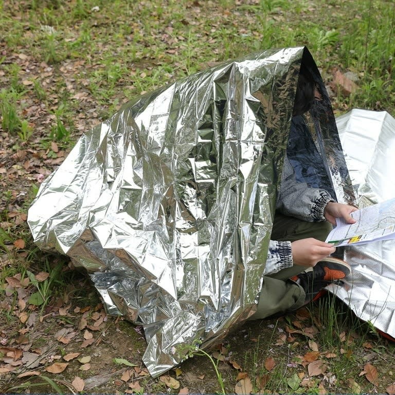 A person under an emergency blanket