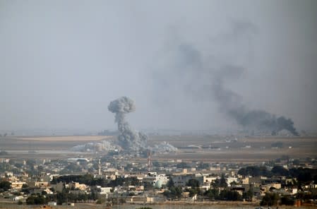 Smoke rises over the Syrian town of Ras al-Ain, as seen from the Turkish border town of Ceylanpinar