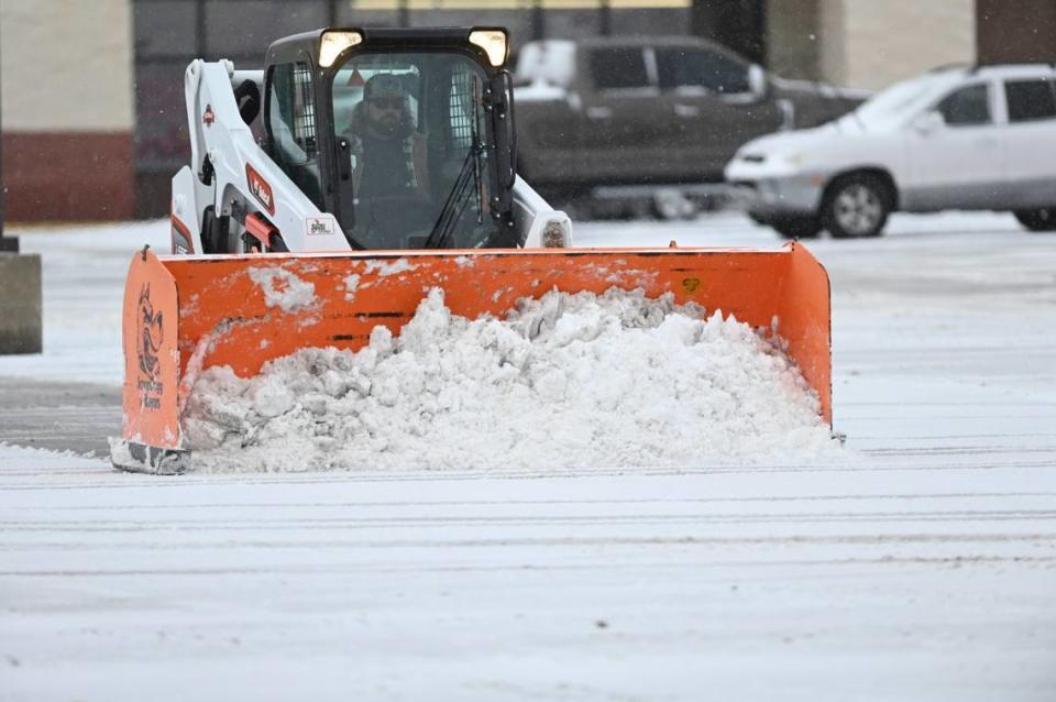 A snowplow cleared a parking lot at a shopping center Thursday, March 10, 2022, near Shawnee Mission Parkway and Lackman Road.