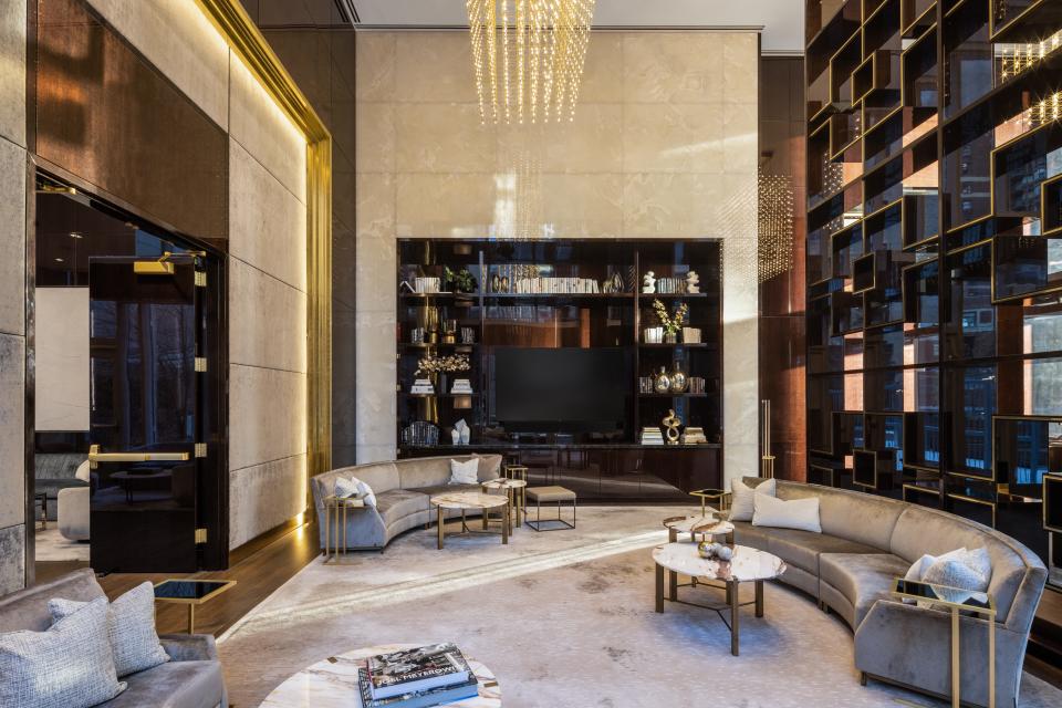 a seating area and built-in bookshelf on the 14th floor of luxury skyscraper Central Park Tower