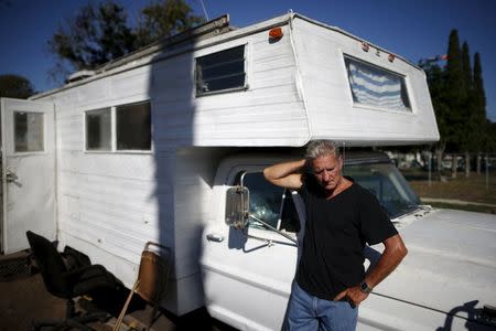 Nathan Allen, 65, poses for a portrait in front of the motorhome where he sleeps in a homeless RV and tent encampment near LAX airport in Los Angeles, California, United States, October 26, 2015. REUTERS/Lucy Nicholson